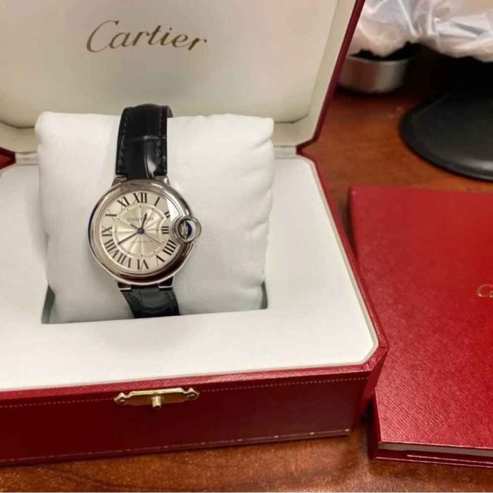 Sold 
Cartier Silver Watch with Black Strap 33 mm
